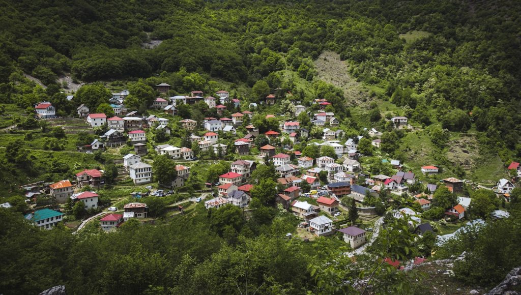 aerial view of houses on green grass field during daytime